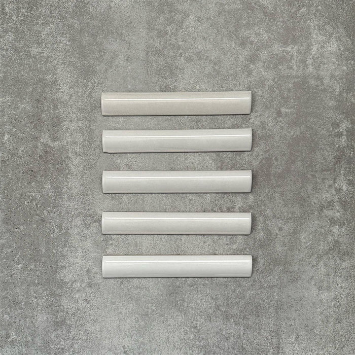 Zellige Weiß Bordürenfliese Keramikfliesen im marokkanischen Stil im Format 3 × 20 cm, in einer sauberen Reihe angeordnet, mit glatter, glänzender Oberfläche.