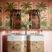 Badezimmer mit Atlas Pink Moroccan Mini Brick Matt Wandfliesen im Format 5 × 15 cm im Fischgrätmuster, kombiniert mit tropischer Palmentapete, geschnitzten Holzspiegeln und Waschbecken in Marmoroptik für ein luxuriöses, eklektisches Interior.