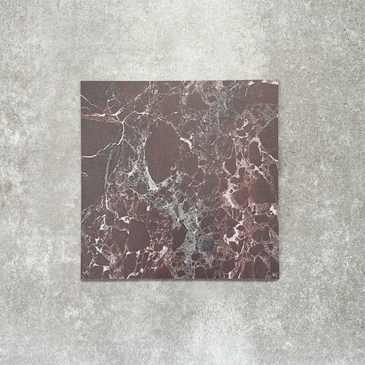Close-up of Divine Levant Rouge matt marble-effect tile in a 30cm x 30cm format, featuring deep burgundy and rich red tones with intricate white and grey marble-inspired veining. The bold natural stone effect and dramatic colour variation create a luxurious statement finish, ideal for chequerboard floor designs, feature areas and characterful interior spaces.