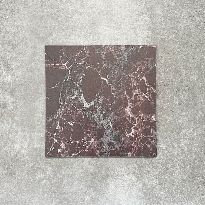 Close-up of Divine Levant Rouge matt marble-effect tile in a 30cm x 30cm format, featuring deep burgundy and rich red tones with intricate white and grey marble-inspired veining. The bold natural stone effect and dramatic colour variation create a luxurious statement finish, ideal for chequerboard floor designs, feature areas and characterful interior spaces.