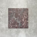 Close-up of Divine Levant Rouge matt marble-effect tile in a 30cm x 30cm format, featuring deep burgundy and rich red tones with intricate white and grey marble-inspired veining. The bold natural stone effect and dramatic colour variation create a luxurious statement finish, ideal for chequerboard floor designs, feature areas and characterful interior spaces.