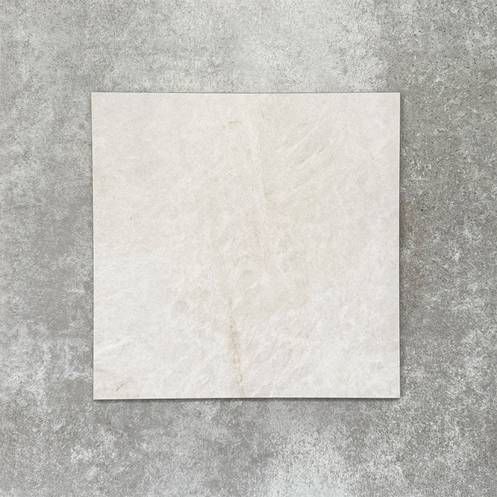 Close-up of Divine Taj Mahal matt marble-effect tile in a 30cm x 30cm format, featuring soft ivory and warm cream tones with subtle natural stone-inspired movement. The understated marble effect creates a timeless and elegant finish, making it ideal for chequerboard floor designs, bathrooms, hallways and sophisticated interior spaces.