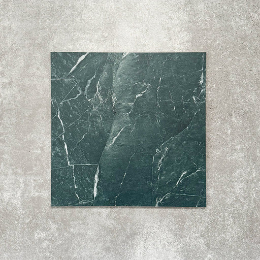 Close-up of Divine Verde Green matt marble-effect tile in a 30cm x 30cm format, featuring rich green tones with elegant white veining and natural marble-inspired movement. The bold stone effect creates a luxurious, timeless finish, making it ideal for statement chequerboard floors, feature areas and sophisticated interior schemes.