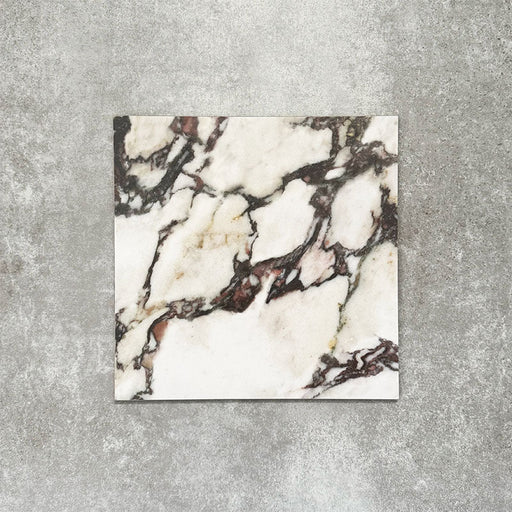 Close-up of Divine Viola matt marble-effect tile in a 30cm x 30cm format, featuring a crisp white background with dramatic burgundy, plum and charcoal veining. Inspired by luxurious natural marble, the striking contrast and rich colour variation make it ideal for statement chequerboard floors, feature areas and elegant interior schemes.
