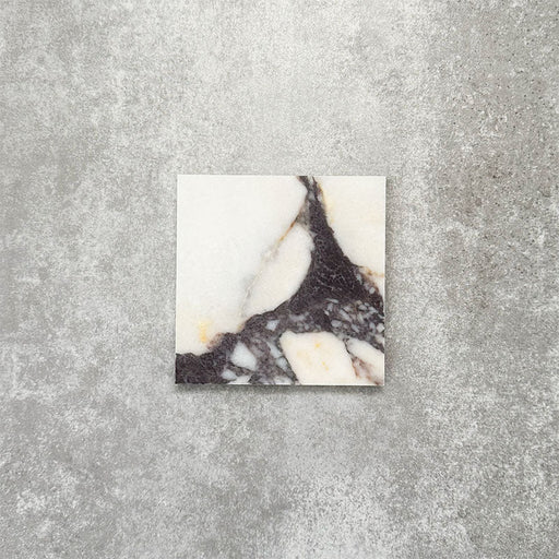 Fayrouz Calacatta Viola honed natural marble tile in a 15.2cm x 15.2cm square format, featuring a creamy white background with bold purple veining and subtle warm gold tones, creating a luxurious and timeless natural stone finish.