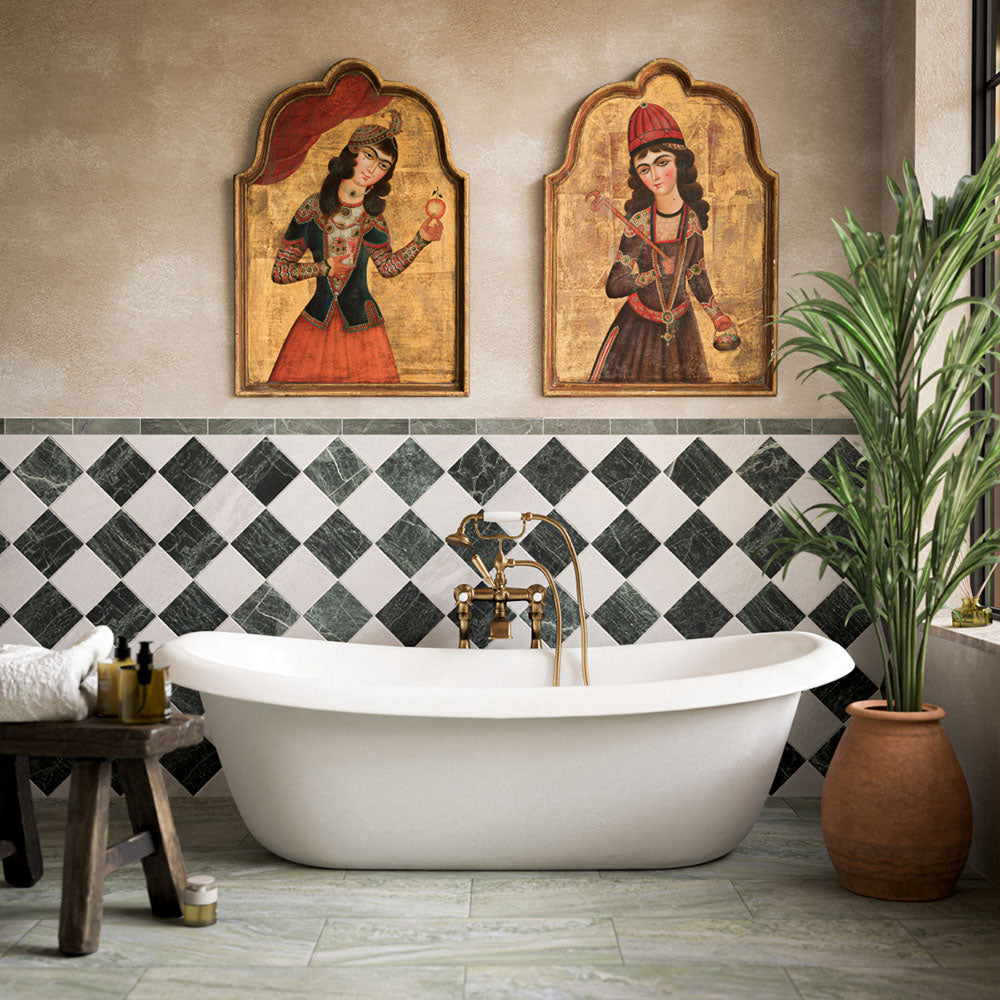 Bathroom featuring Fayrouz Verde tumbled natural marble tiles in a striking diamond pattern around a freestanding bath, complemented by brass fixtures, warm neutral walls, botanical décor and Persian-inspired artwork for a luxurious, characterful finish.