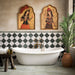 Bathroom featuring Fayrouz Verde tumbled natural marble tiles in a striking diamond pattern around a freestanding bath, complemented by brass fixtures, warm neutral walls, botanical décor and Persian-inspired artwork for a luxurious, characterful finish.