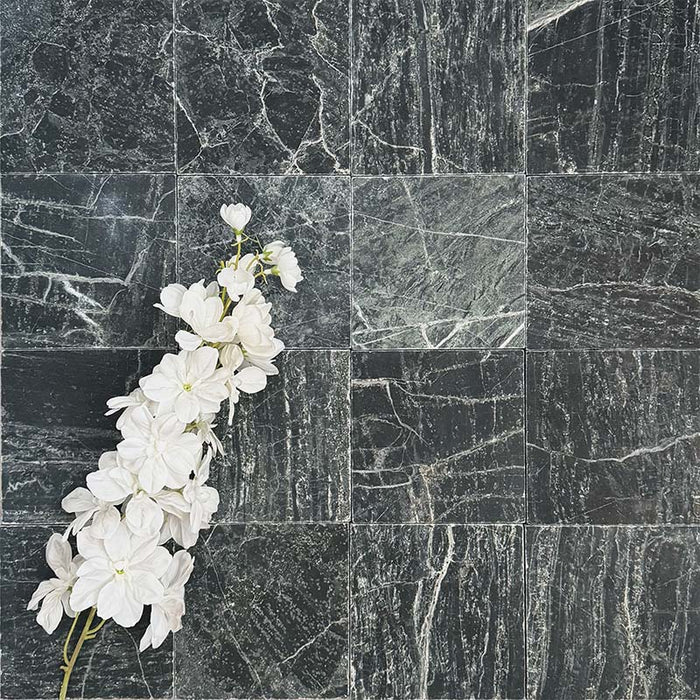 Fayrouz Verde tumbled natural marble tiles in a 15.2cm x 15.2cm format, showcasing rich deep green tones, striking white veining and authentic stone variation with a beautifully aged tumbled finish.