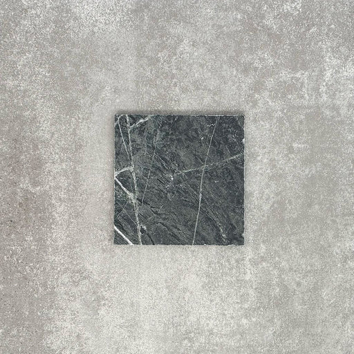 Close-up of Fayrouz Verde tumbled natural marble tiles in a 15.2cm x 15.2cm format, showcasing rich deep green tones, striking white veining and authentic stone variation with a beautifully aged tumbled finish.