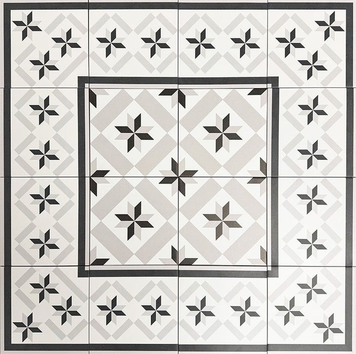 Gruppenanordnung mit Canterbury Stern Fliesen im viktorianischen Stil im Format 20 × 20 cm, arrangiert zu einer dekorativen Fläche mit Bordürendetails. Präsentiert wird das klassische Sternmotiv in Schwarz-, Grau- und Weißtönen.