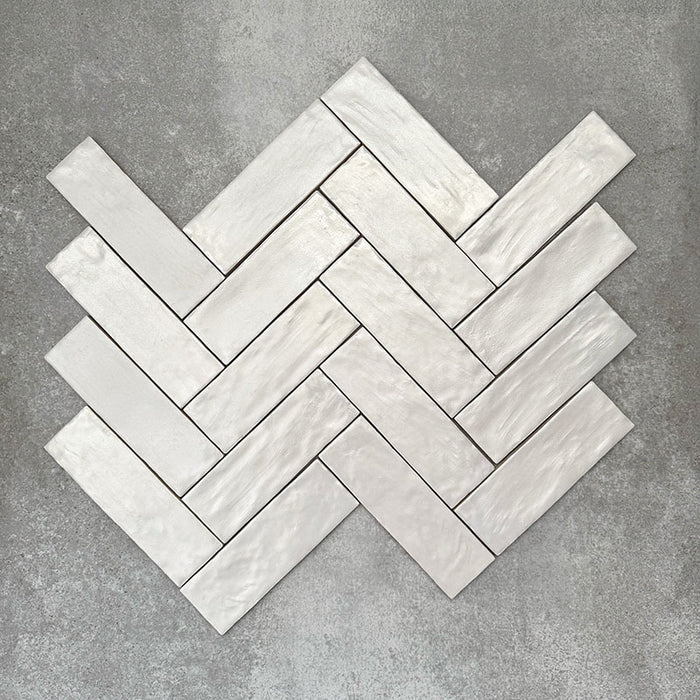 Fischgrätmuster mit Zellige Auster Brick Keramikfliesen im marokkanischen Stil im Format 6,5 × 20 cm, bei dem das schräge Verlegemuster die handgefertigten Kanten, die glänzende Auster-Glasur und die natürliche tonale Variation betont – für ein zeitloses, handwerkliches Finish.