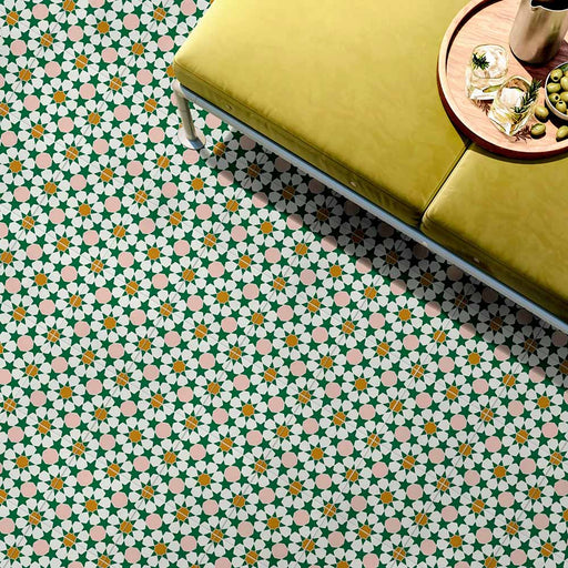 Innenboden mit Kuba Tanane Feinsteinzeugfliesen im marokkanischen Stil im Format 20 × 20 cm, verlegt in einem sich wiederholenden Stern- und Geometriemuster in Grün-, Weiß-, zarten Rosé- und warmen Gelbtönen. Kombiniert mit einer senffarben gepolsterten Bank und Accessoires, um das filigrane Design und die lebendige Farbpalette wirkungsvoll hervorzuheben.