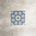 Single Fez Mini Artisan 15x15cm Moroccan-style porcelain tile displayed against a textured grey background, highlighting the intricate multicolour geometric star pattern in soft blue, blush pink, green and terracotta tones with an encaustic-inspired finish.