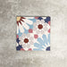Fez Fiera Moroccan style porcelain tile with a geometric star pattern in blue, terracotta, grey and cream, shown as a single 20cm x 20cm tile
