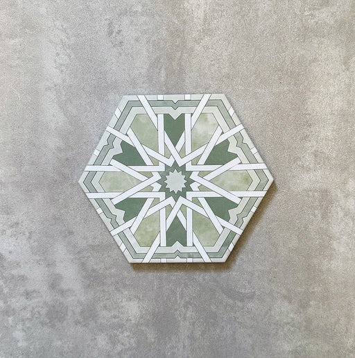 Einzelne Medina Hormuz Grün Feinsteinzeug-Hexagonfliese im marokkanischen Stil im Format 18,7 × 21,6 cm, mit einem markanten, sterninspirierten geometrischen Muster in Grün- und Weißtönen, gezeigt vor neutralem Hintergrund.