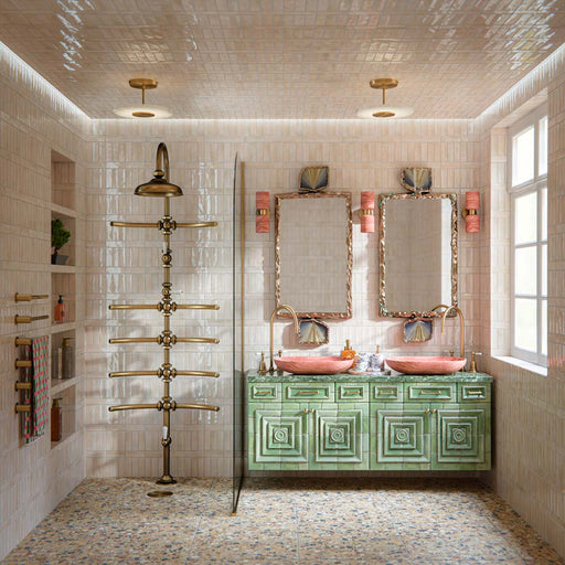 Luxury bathroom featuring Stuzzi Amber 60x60cm classical terrazzo style porcelain floor tiles with a 4D brushed finish, paired with soft blush gloss wall tiles, a sage green vanity unit, pink basins, brushed brass fittings and vintage-inspired details.
