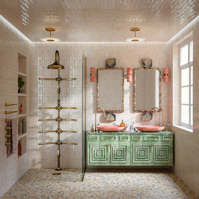 Luxury bathroom featuring Stuzzi Amber 60x60cm classical terrazzo style porcelain floor tiles with a 4D brushed finish, paired with soft blush gloss wall tiles, a sage green vanity unit, pink basins, brushed brass fittings and vintage-inspired details.