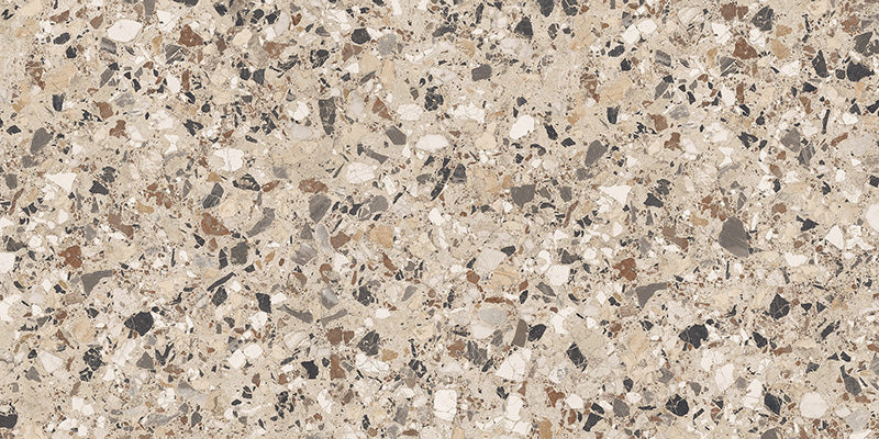Close-up of the Stuzzi Dolmia 60x120cm terrazzo style porcelain tile, featuring a warm beige base with a blend of cream, taupe, brown, grey and charcoal stone fragments. The realistic 4D brushed finish enhances the texture and depth, creating an authentic terrazzo effect.
