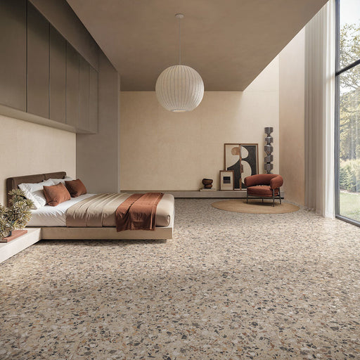 Contemporary bedroom featuring Stuzzi Dolmia 60x60cm terrazzo style porcelain floor tiles with a warm beige base and multicoloured stone fragments. The realistic 4D brushed finish adds depth and texture, complementing the soft neutral décor, earthy tones and minimalist interior design.
