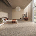Contemporary bedroom featuring Stuzzi Dolmia 60x60cm terrazzo style porcelain floor tiles with a warm beige base and multicoloured stone fragments. The realistic 4D brushed finish adds depth and texture, complementing the soft neutral décor, earthy tones and minimalist interior design.
