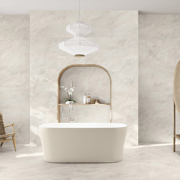 Bathroom interior featuring Taj Mahal Matt 60 × 120cm marble effect porcelain wall and floor tiles, showcasing soft cream tones with gentle, flowing veining. The larger format enhances the sense of space, creating a seamless, spa-like setting complemented by warm wood accents and soft, natural light.