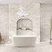 Bathroom interior featuring Taj Mahal Matt 60 × 120cm marble effect porcelain wall and floor tiles, showcasing soft cream tones with gentle, flowing veining. The larger format enhances the sense of space, creating a seamless, spa-like setting complemented by warm wood accents and soft, natural light.