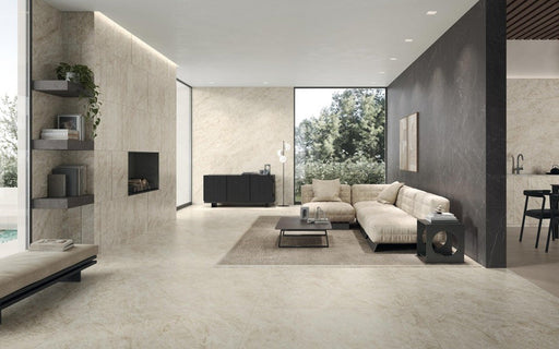 Open-plan living space featuring Taj Mahal Matt 60 × 60cm marble effect porcelain wall and floor tiles, showcasing soft cream tones with delicate, natural veining. The matt finish creates a calm, seamless foundation, complemented by layered textures, warm neutrals, and contemporary architectural lines.