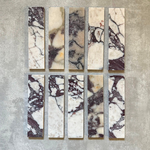 Fayrouz Viola 5 × 20 cm Naturmarmorfliesen mit geschliffener Oberfläche, mit weißer Basis und markanter bordeauxroter sowie warmtoniger Maserung, im sauberen Raster verlegt, um natürliche Variation und die charakteristische Steinstruktur hervorzuheben.